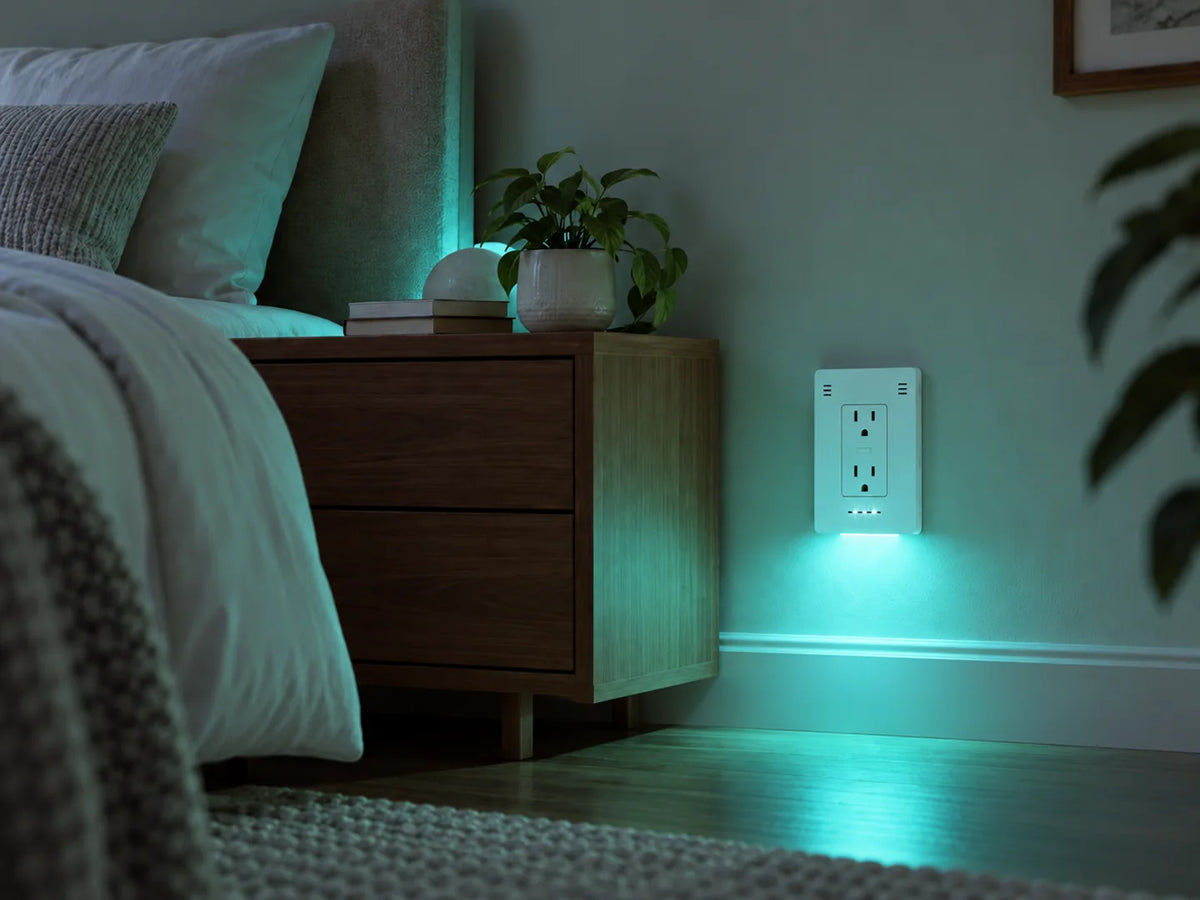 InvisOutlet Aura lighting the same bedroom in teal